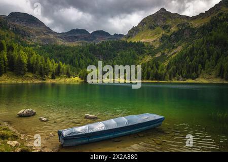 Great view with moored boat on the lake and beautiful high mountains in background, Duisitzkarsee Lake, Styria, Austria, Europe Stock Photo