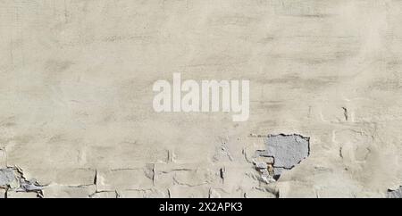 Old and cracked, dilapidated and uneven brick wall with yellowed whitening. Texture and background of faded building wall, painted with whiting Stock Photo