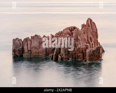 Geological feature called Rocce Rosse (red rocks) in Arbatax at the sunrise; east coast of Sardinia, Italy Stock Photo