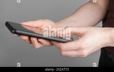 Hands using mobile phone, texting, reading news, social media, scrolling network online, finger clicking. Stock Photo