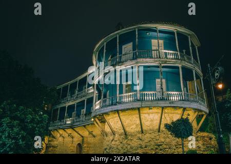 Old traditional Georgian house with wooden balcony in old Tbilisi (Georgia) by night Stock Photo