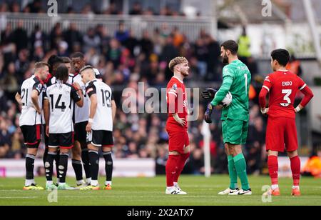 Liverpool's Harvey Elliott (left) and Liverpool goalkeeper Alisson Becker in discussion during the Premier League match at Craven Cottage, London. Picture date: Sunday April 21, 2024. Stock Photo