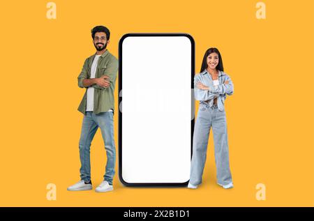 Two people next to a large smartphone mock Stock Photo