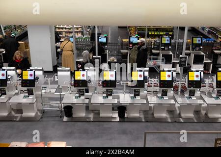 M&S Marks and Spencer customers using self scan self service digital technology checkout scanning machines in store food hall London UK  KATHY DEWITT Stock Photo