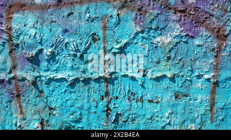 Bright blue colour dripped paint on old concrete wall background. Natural paintbrush strokes and textured rough cement. Stock Photo
