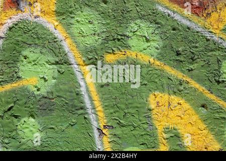 Green dripped paint on old concrete wall. Natural paintbrush strokes and textured rough cement. Stock Photo