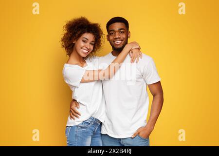 Cheerful african american man and woman embracing Stock Photo