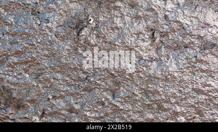 Concrete grey with pink tint shiny wall background on the street in day light. Stock Photo