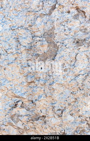 Old concrete glitter wall grunge background or texture with a pink tint. Vertical photo. Stock Photo
