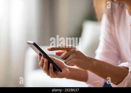 Focused black lady using a digital tablet Stock Photo