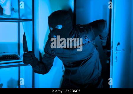 Burglar with knife caught during a home invasion Stock Photo