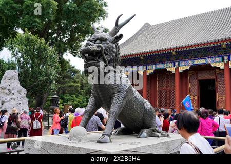 New Summer Palace, Beijing, China, Asia, Visitors admire an imposing stone sculpture of a mythical creature in front of a temple, Beijing Stock Photo