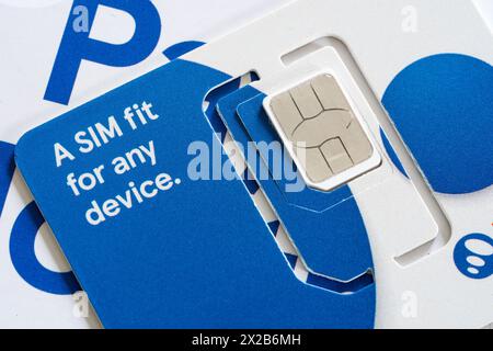 Closeup on a universal removable nano sim card and adapter for a smartphone, provided by Tesco Mobile, England Stock Photo