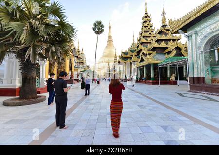 Shwedagon Pagoda, Yangon, Myanmar, Asia, people visiting a large pagoda, some taking photos, Asia Stock Photo