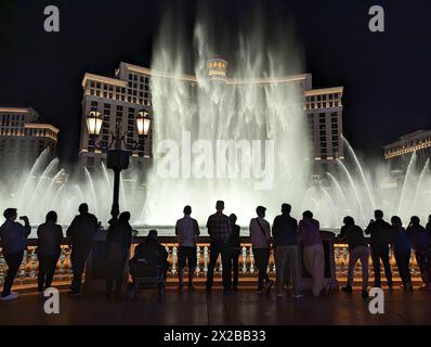 A crowd of people gather to watch the famous water fountain show in front of the Bellagio hotel. Stock Photo