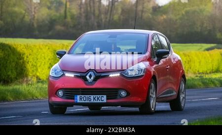Bicester,UK- Apr 21st2024: 2016 red Renault Clio diesel engine classic car driving on a British road Stock Photo
