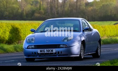 Bicester,UK- Apr 21st2024: 1998 blue Fiat Coupe classic car driving on a British road Stock Photo