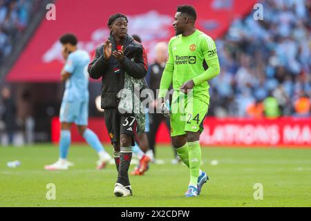 London, UK. 21st Apr, 2024. Manchester United midfielder Kobbie Mainoo (37) and Manchester United goalkeeper Andre Onana (24) celebrate with fans after winning on penalties during the Coventry City FC v Manchester United FC Emirates FA Cup Semi-Final match at Wembley Stadium, London, England, United Kingdom on 21 April 2024 Credit: Every Second Media/Alamy Live News Stock Photo