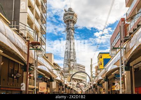 October 7, 2023: Street view of Shinsekai and Tsutenkaku tower in Osaka, Japan. Shinsekai, lit. New World, is a retro area developed before the war an Stock Photo