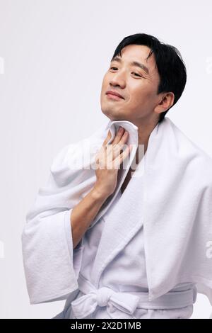 a middle aged man who wipes his neck with a white towel Stock Photo