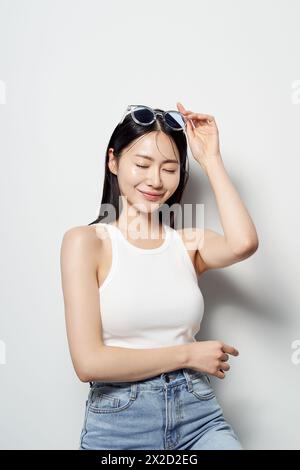 Asian woman staring straight ahead in clear sunglasses Stock Photo
