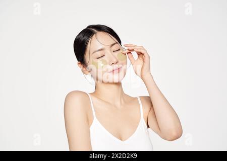 Asian woman posing with eye patches on both cheeks Stock Photo