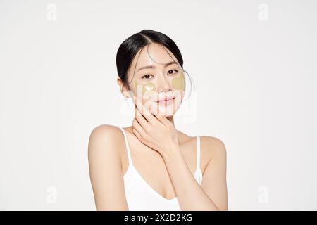 Asian woman posing with eye patches on both cheeks Stock Photo