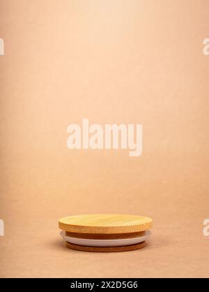 Round wooden stack as a podium with empty space for place food, cosmetics products designs isolated on recycle paper background. Mockup display on bro Stock Photo