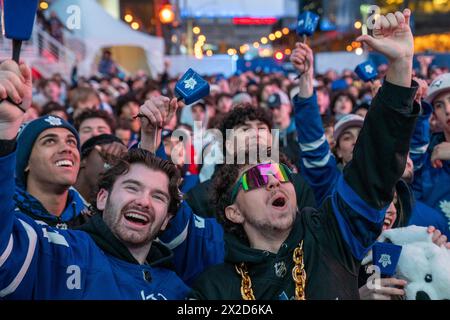 Fans watching the game on a giant screen react as the Toronto Maple Leafs score a goal against Boston Bruins, at Maple Leaf Square outside Scotiabank Arena. During Toronto Maple Leafs playoff games, Maple Leaf Square transforms into a sea of blue and white, echoing with the chants of passionate fans eagerly rallying behind their team's quest for victory. The electric atmosphere radiates anticipation and excitement, creating unforgettable memories for both die-hard supporters and casual observers alike. (Photo by Shawn Goldberg/SOPA Images/Sipa USA) Stock Photo