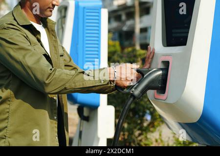 Cropped image of driver using public charging point Stock Photo