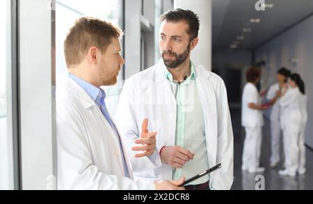 Doctors and nurses talking in corridor, Hospital, Spain Stock Photo