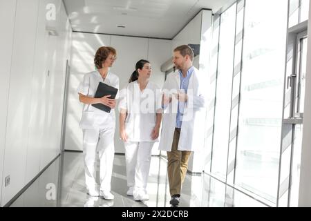 Doctors and nurses walking in corridor, Hospital, Spain Stock Photo