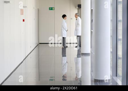 Doctors and nurses talking in corridor, Hospital Stock Photo