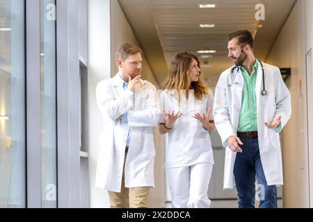 Doctors and nurses walking in corridor, Hospital Stock Photo