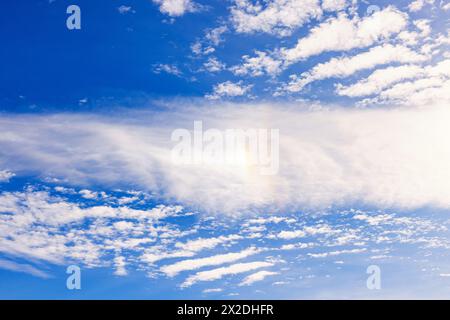 Sun halo on the blue sky with clouds Stock Photo