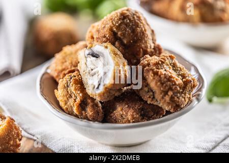 Fried mushrooms in breadcrumbs in a white bowl. Homemade crispy deep fried mushrooms. Stock Photo