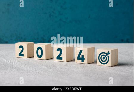 Business goal planning for the year 2024. Year 2024 with target symbol on wooden cubes. Stock Photo