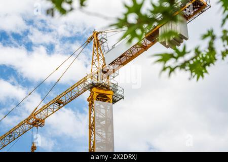 Construction crane working on large construction site Stock Photo