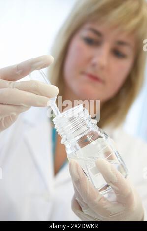 Technical staff taking samples of chemical solution. Laboratory, Fundación Inbiomed, Genetrix Group. Center for research in stem cells and regenerativ Stock Photo