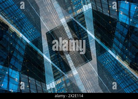 symmetry and mirrored geometry pattern, reflected skyscrapers and modern buildings abstract background, lines and tunnel futuristic technology concept Stock Photo