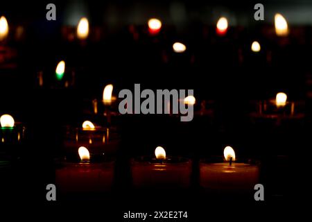 Colorful candles burning on the dark for religious celebrations as Christmas or Diwali Stock Photo