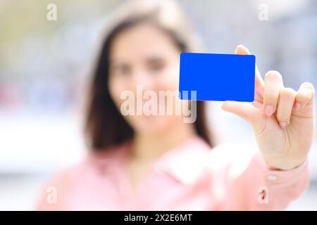 Close up portrait of an elegant woman hand showing black credit card mock up in the street Stock Photo