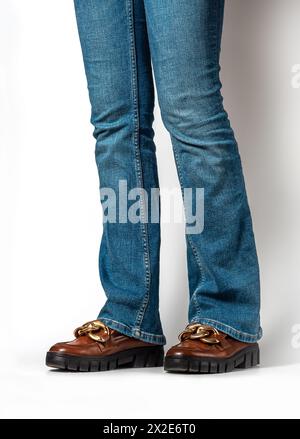 Close-up of female legs in jeans and brown casual leather shoes. Women's summer shoes Stock Photo