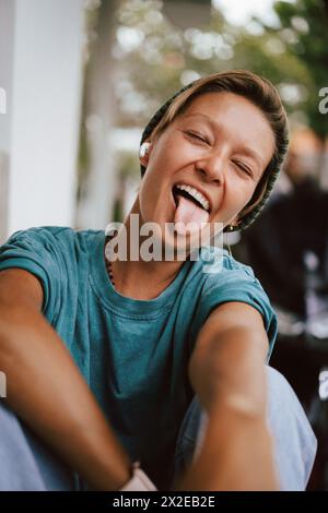 Emotional portrait, young woman, tongue hanging out. Stock Photo