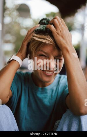 Close-up of playful woman covering eyes with knit hat Stock Photo