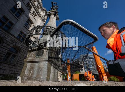 Leipzig, Germany. 22nd Apr, 2024. Tom Schmerler cleans the town hall fountain on Burgplatz in Leipzig. The city starts the fountain season with the commissioning of the town hall fountain. Over the past few days, the city cleaning staff have gradually put the 23 water features into operation. Prior to this, the systems were technically checked and cleaned. The town hall fountain, popularly known as the 'Pied Piper Fountain', was designed by sculptor Georg Wrba and inaugurated in 1908. Credit: Hendrik Schmidt/dpa/Alamy Live News Stock Photo