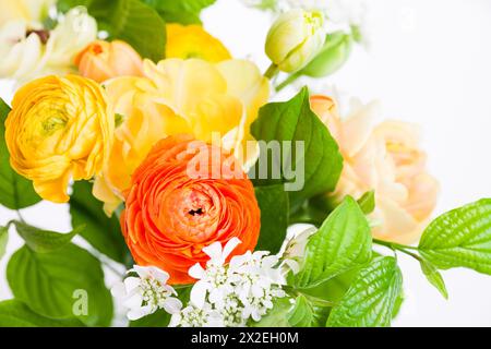 Elegant mixed warm colored spring bouquet close up. Spring flowers. Stock Photo