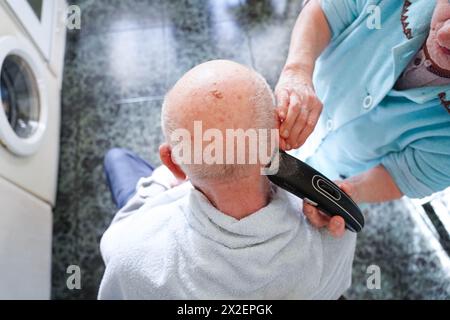 Top view of an older woman helping her husband with personal hygiene. Concept elderly and assistance Stock Photo