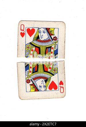 A vintage, well used queen of diamonds playing card torn in half on a ...