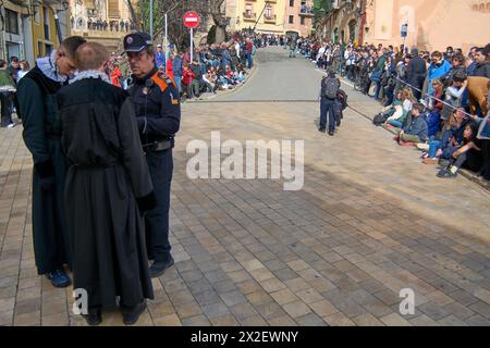 Tarragona, Spain - April 22, 2024: A crowd gathers on the cobblestone streets of Tarragona during Holy Week in anticipation of a religious procession Stock Photo